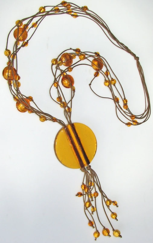a yellow glass bead necklace with some beads and metal