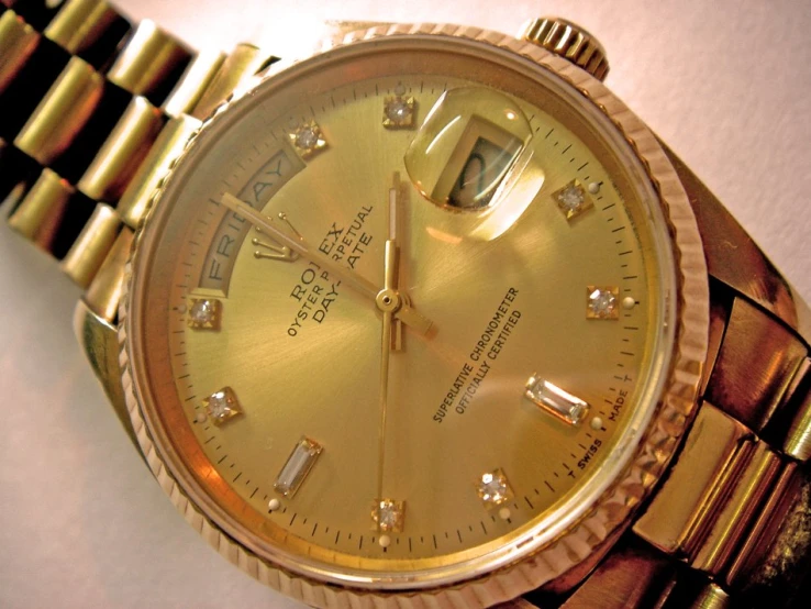 a rolex watches sitting on a white table