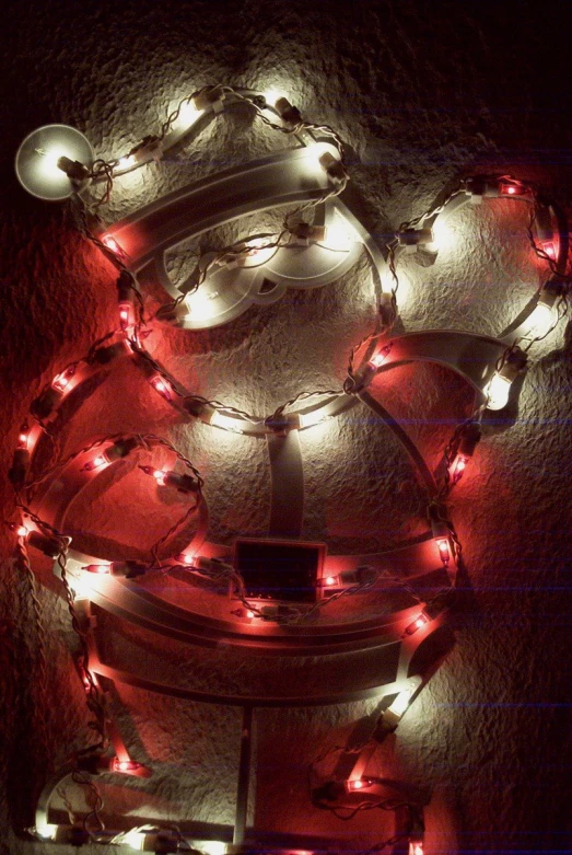 a collection of christmas lights in rows and shapes on a wall