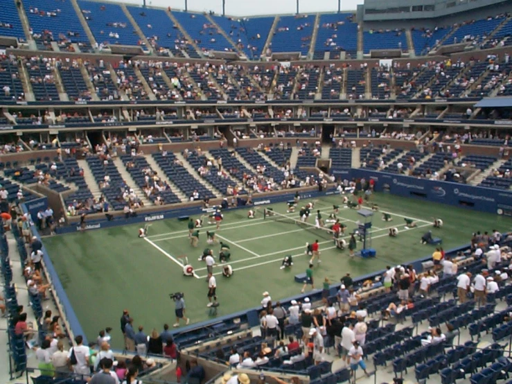 a tennis match is being played in a stadium