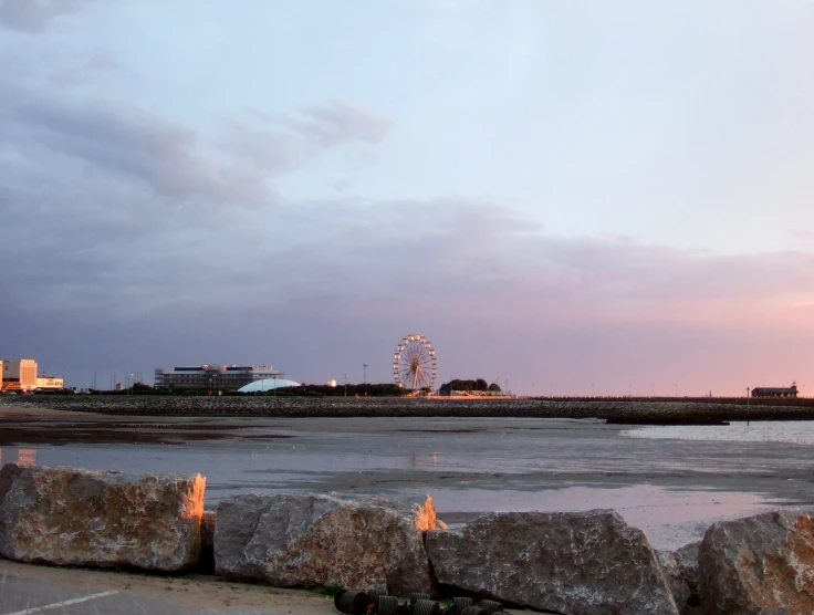 a ferris wheel and a ferris wheel over looking the beach