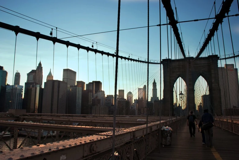 a bridge in the middle of the city with people walking across it