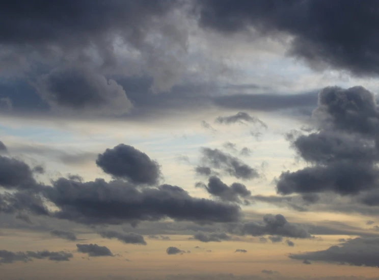 two birds are flying through the dark cloudy sky