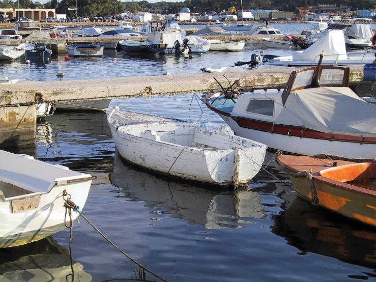 there are many boats at the harbor near a wall