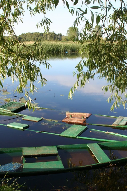 a few green paddle boats floating in water