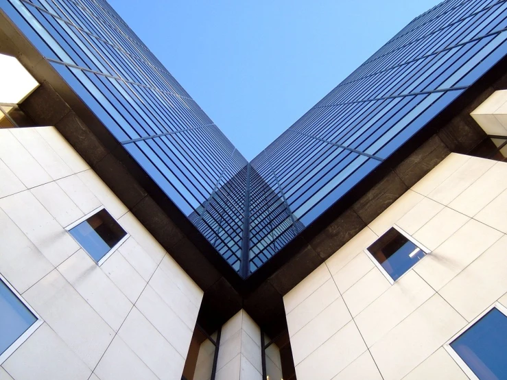 looking up at two tall buildings in front of each other