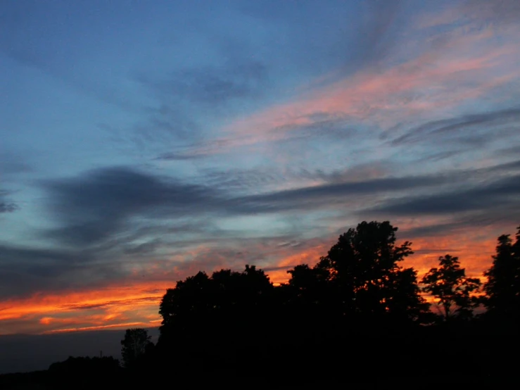 the sun is setting and the clouds are colorful