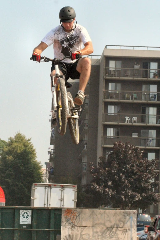 man jumping off a ramp on his bike and doing tricks