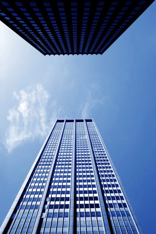 a tall skyscr with windows surrounded by clouds