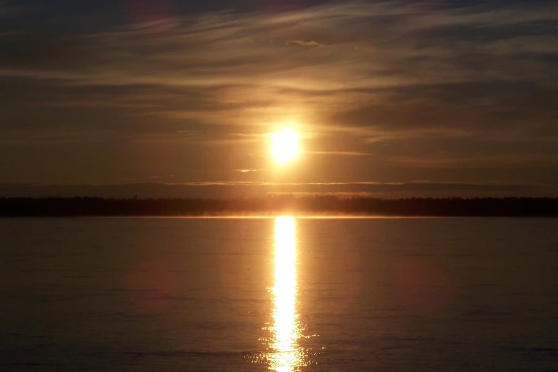 a very bright sun is seen through the clouds