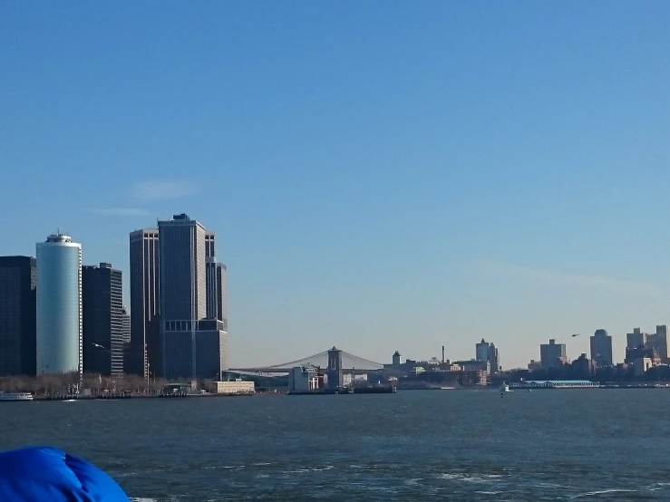 some boats on the water and a large city in the background