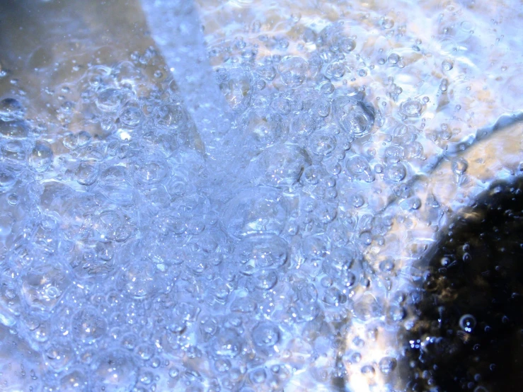 a close up of water, steam, and other things in the bottom of a pan