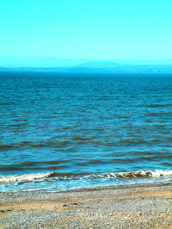 people are out in the water on the beach