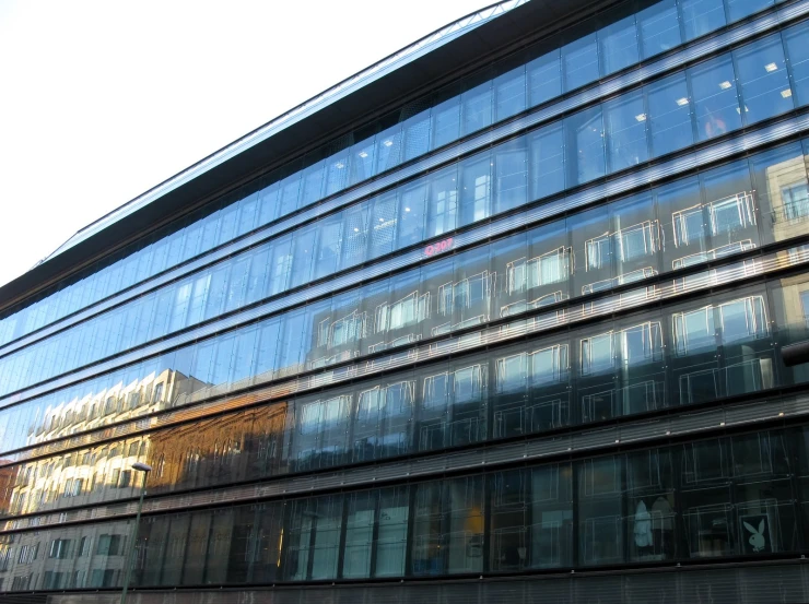 a tall glass building with many windows on it