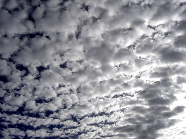 a cloudy sky with several jets in the distance