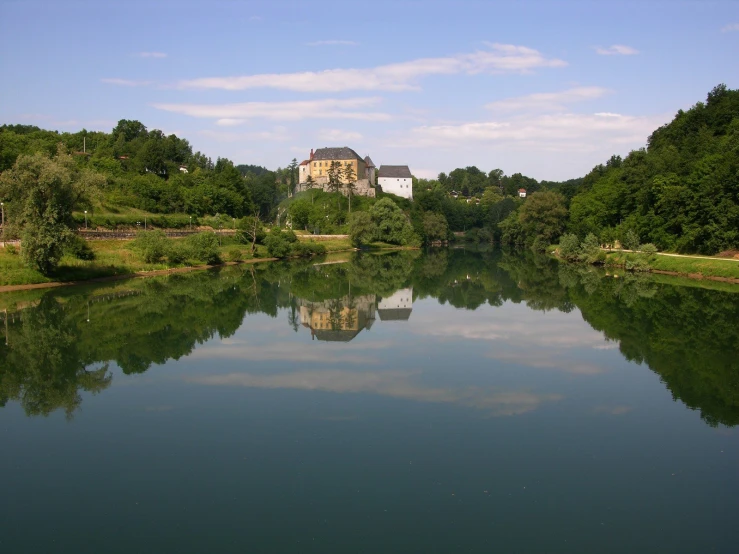 a reflection of some buildings in a pond