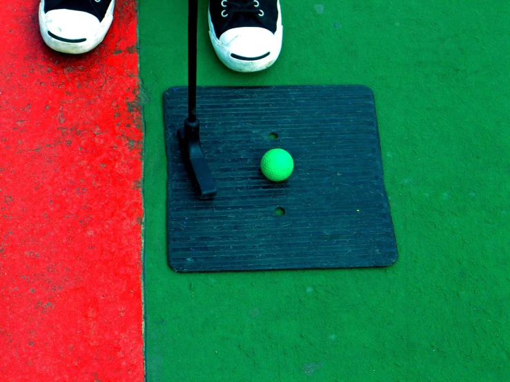 a person with a tennis racquet is standing near a ball