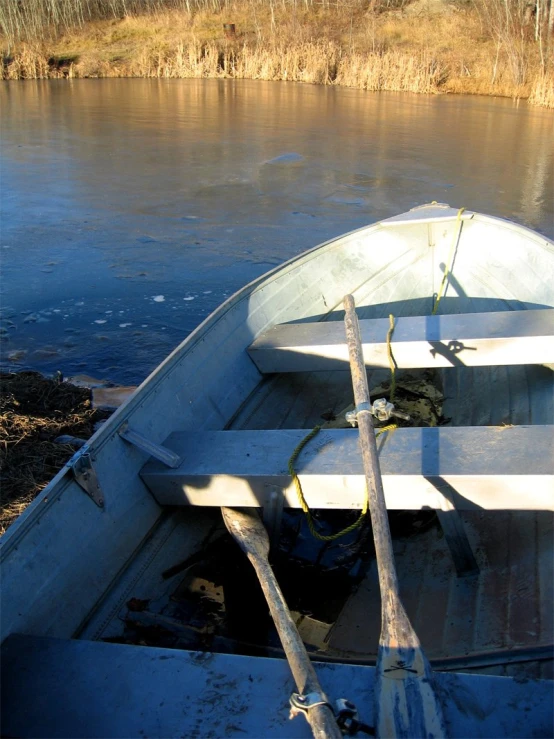 a small boat sits on top of the water