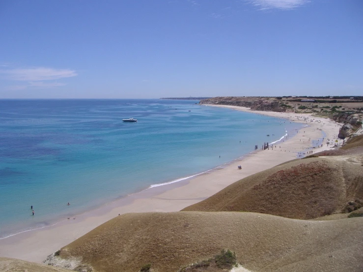 a beach with the ocean on a sunny day