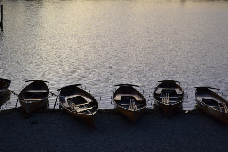 several small boats lined up near a dock