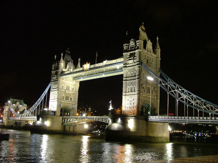 a bridge and its reflection on the water at night