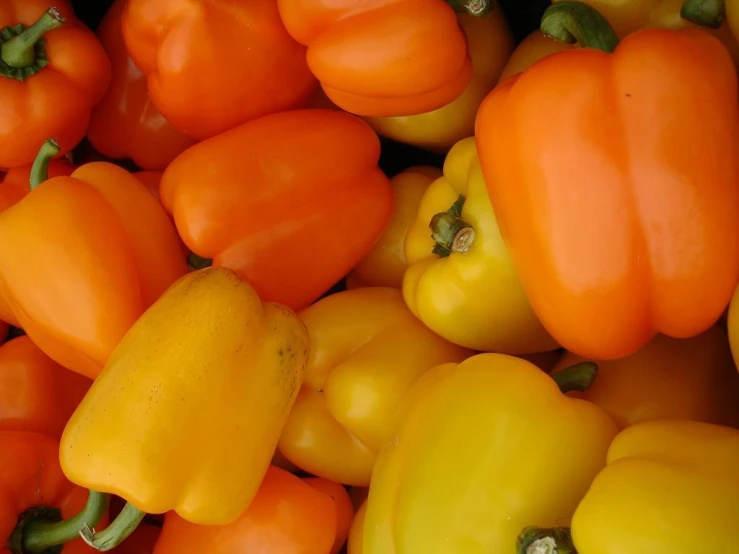 a pile of yellow and red peppers