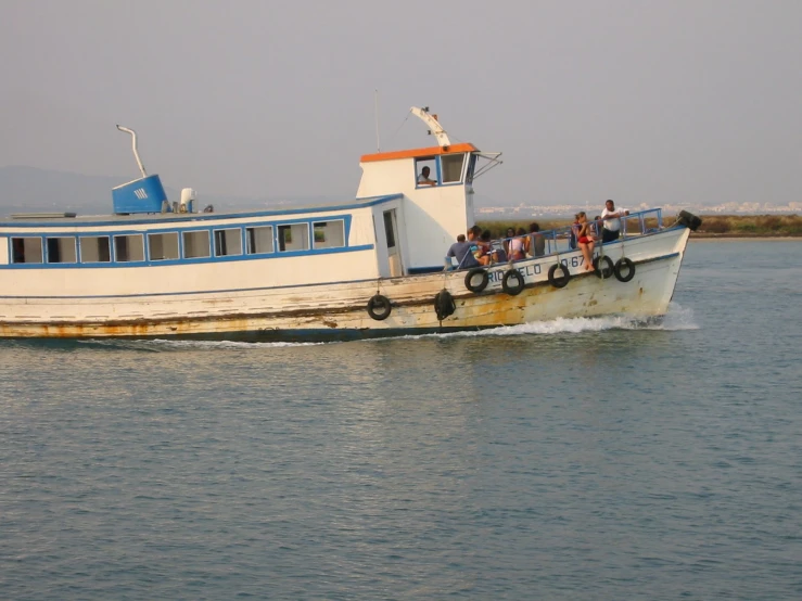 a boat moving along the water with people in it