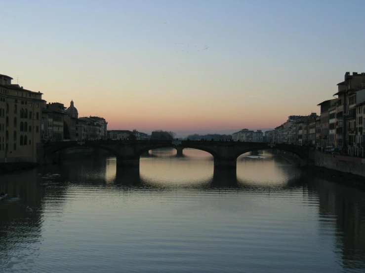 a small bridge that crosses the width of a river