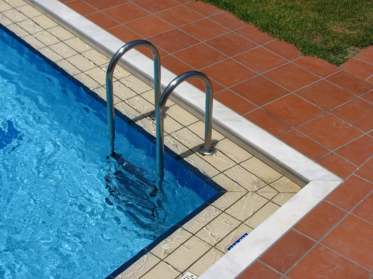 a pool that has a ladder next to it