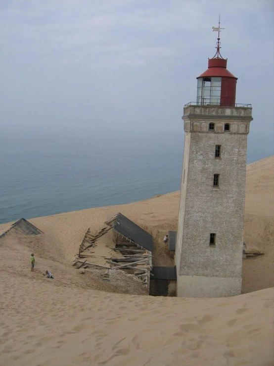 a large tower sits on top of a sandy beach