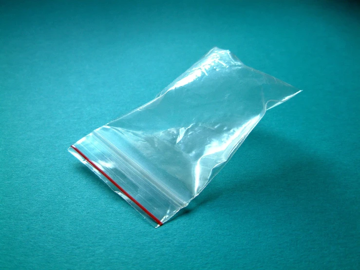 a clear plastic bag with some type of paper sticking out