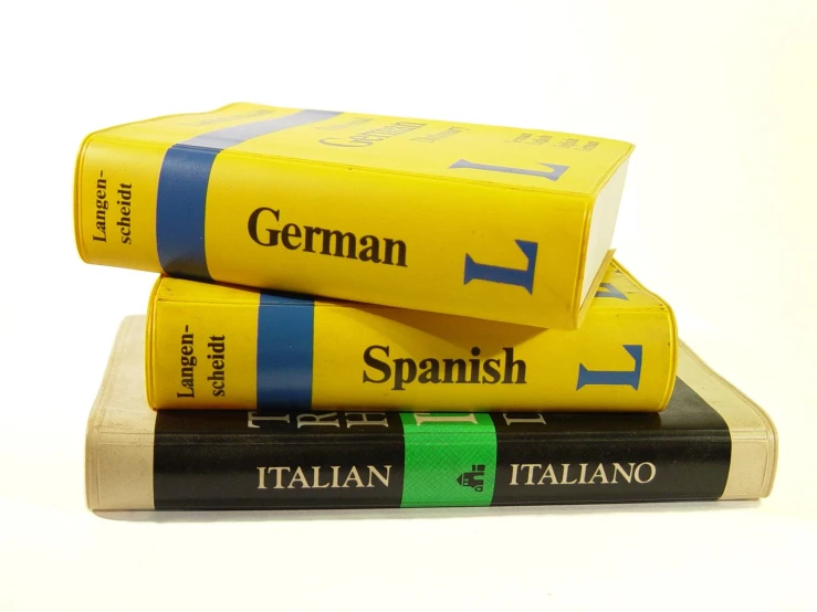 three books stacked on each other in different languages