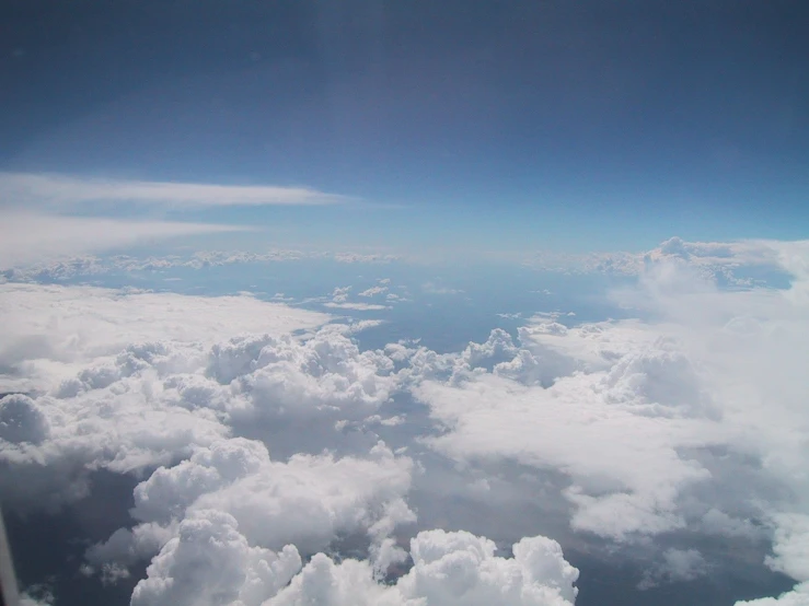 a view from an airplane looking out on the clouds