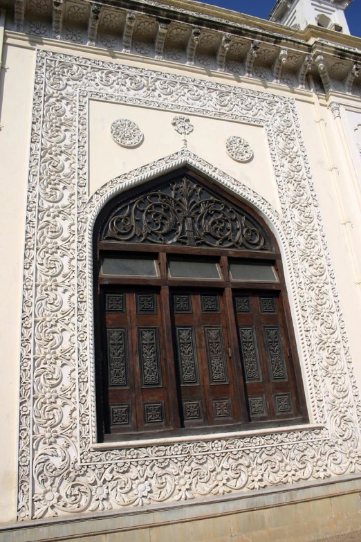 a large white building with wood door and window