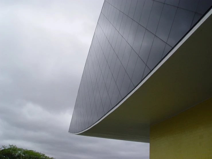 a view from behind an airplane of the wing and side of a building