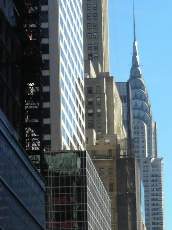 some tall buildings in a large city with skyscrs
