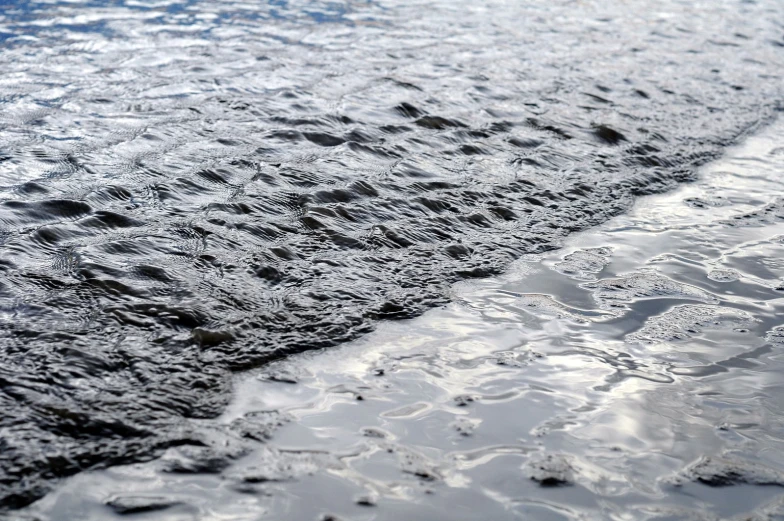 water and sand at the end of a beach