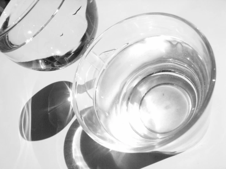 a black and white image of some empty drinking glasses