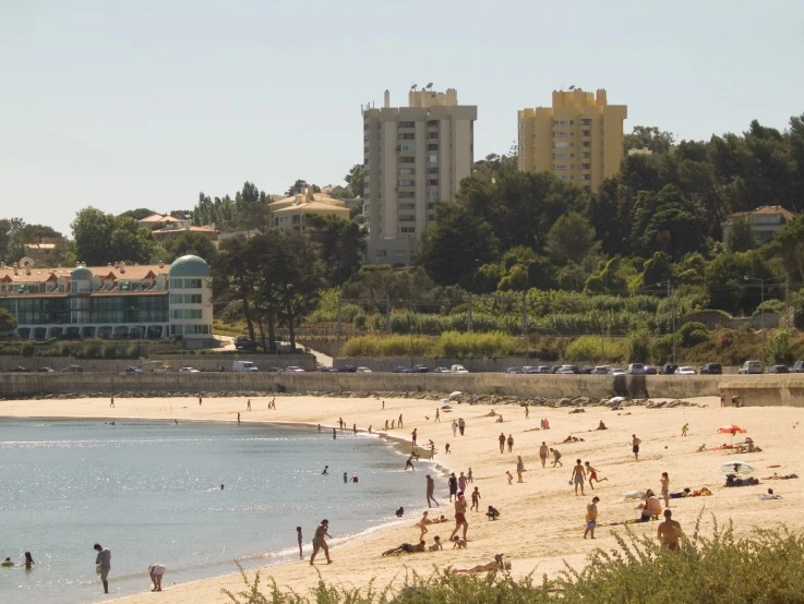 people are enjoying a day at the beach in front of large els