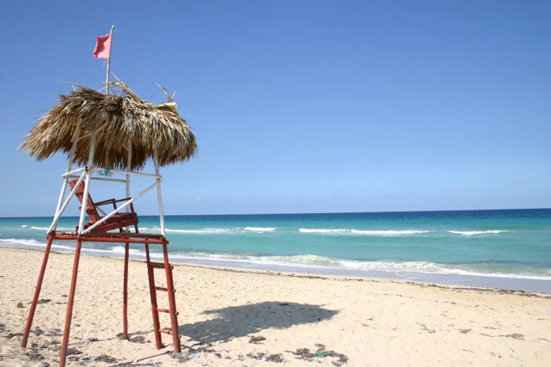 this is an image of a life guard pole with straw roof