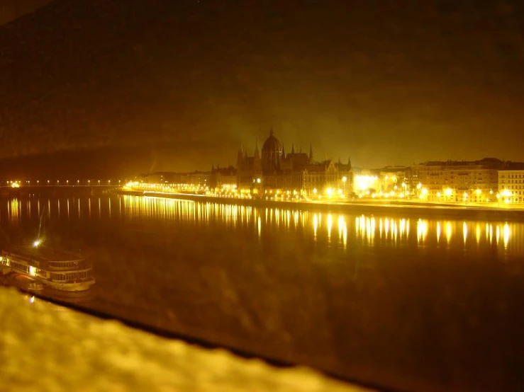 some boats are docked on the river in front of some buildings