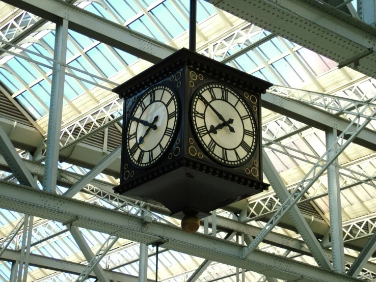 an ornate clock with black hands in an indoor area
