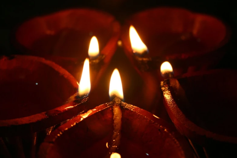 some candles that are lit up in the dark