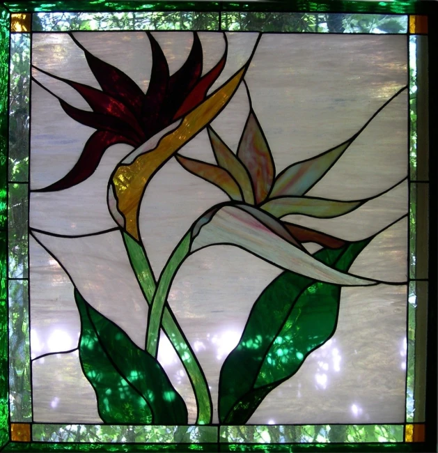 a green stained glass floral design on a window