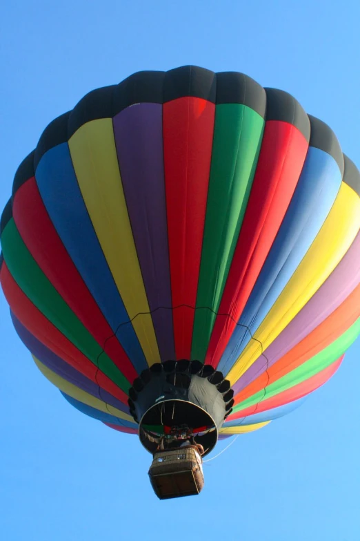 a very large colorful  air balloon in the sky