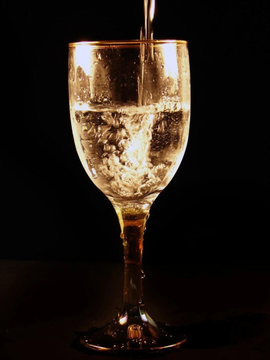 a glass filled with water sits on a table