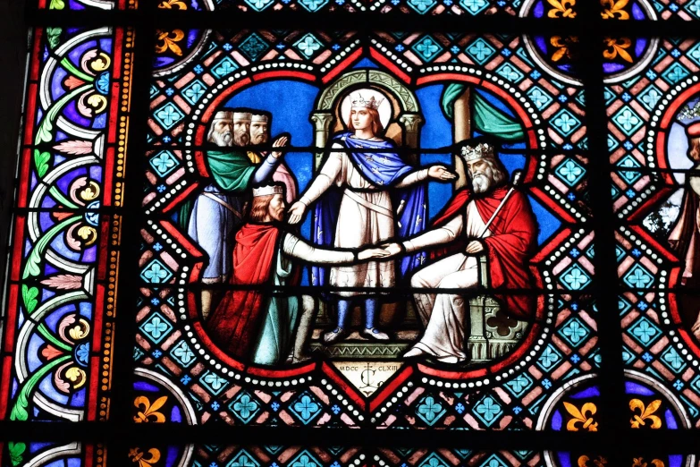 a very large stained glass with an image of jesus handing jesus a doll