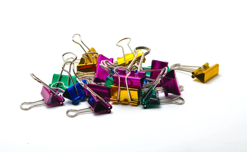 small pile of assorted colored metal binders