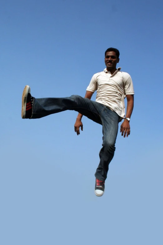 a young man leaps high into the air