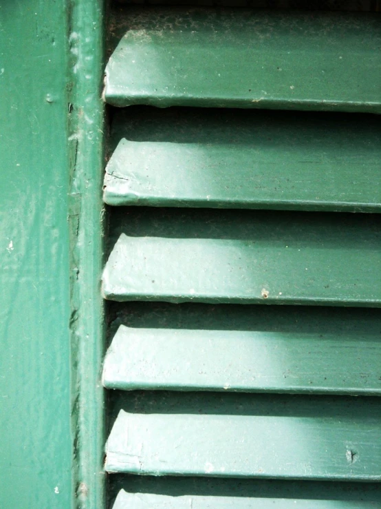 a close up view of a green metal surface